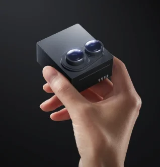 Hesai FTX LiDAR sensor held in hand showing compact size